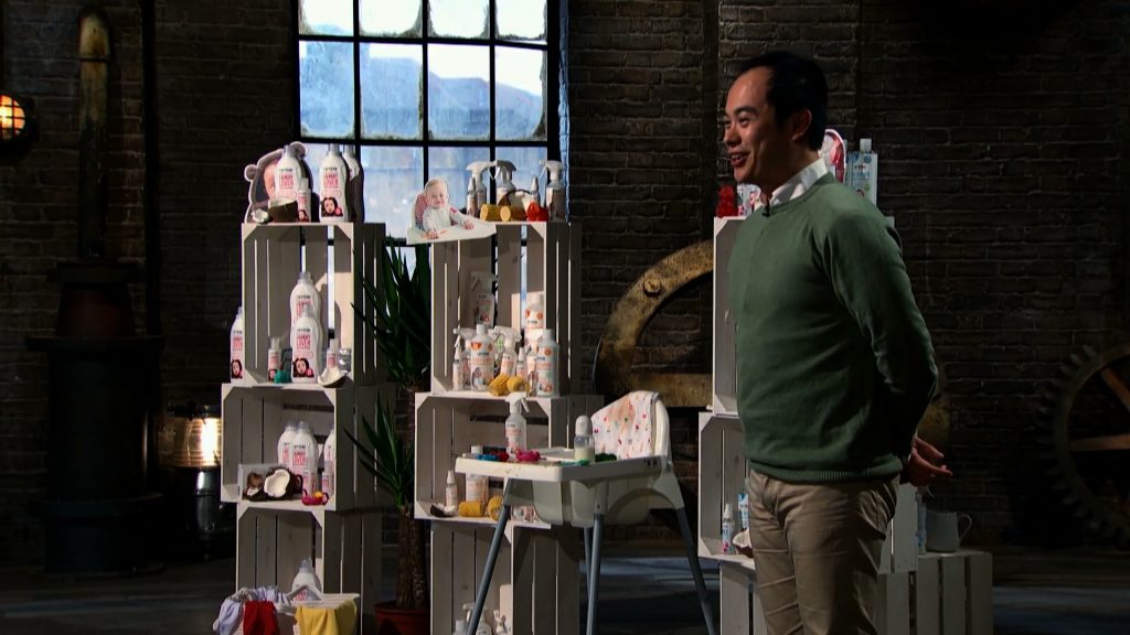 Von Sy smiling in the Den with his range of products displayed behind him