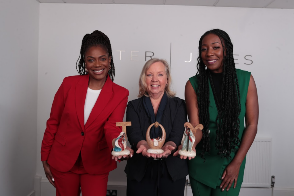 March Muses co-founders, Alison Burton and Natalie Duvall with Dragons' Den businesswoman Deborah Meaden showing a festive decoration that reads 'joy'.