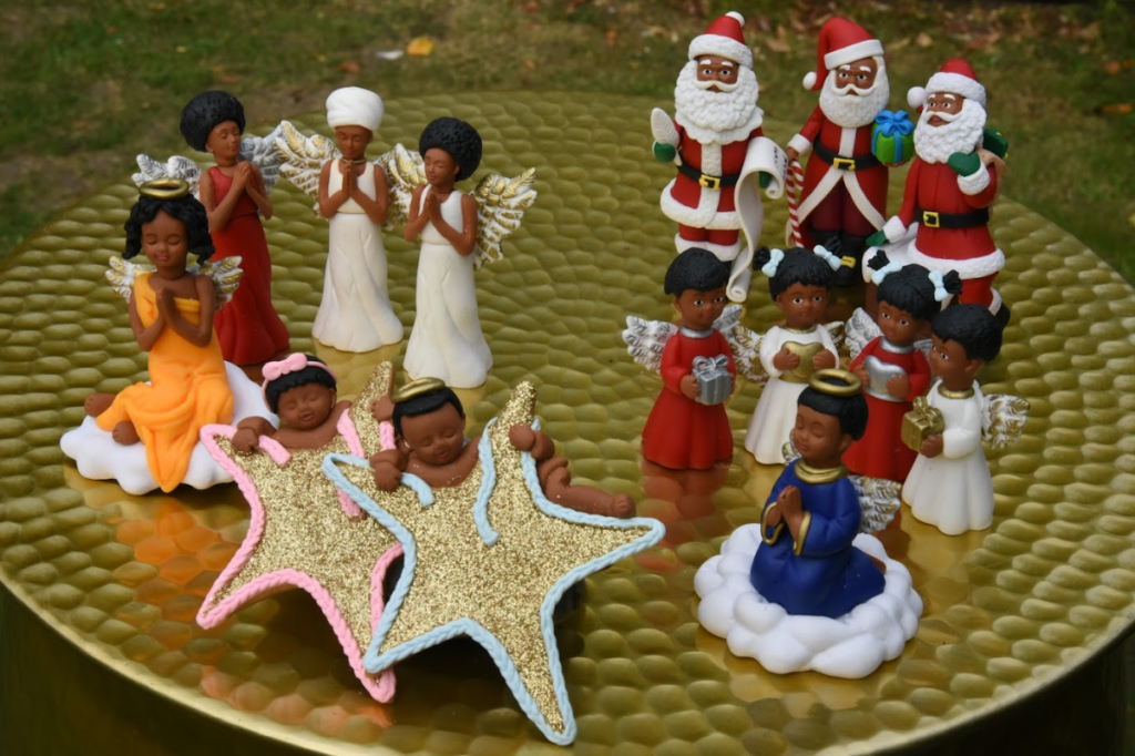March Muses figurines with a range of skin tones, displayed on a festive background. 