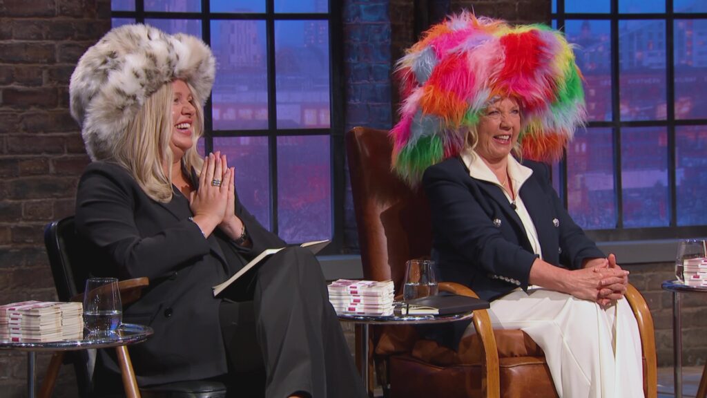 An image of Jenna Meek and Deborah Meaden donning large fluffy hats