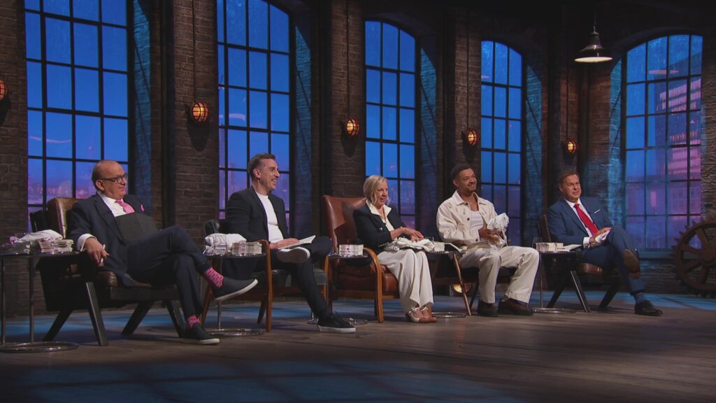 Guest dragon Gary Neville takes his seat beside seasoned Dragons, Deborah Meaden, Steven Bartlett, Touker Suleyman and Peter Jones.